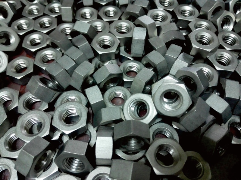 Titanium nuts for precision assembly applications